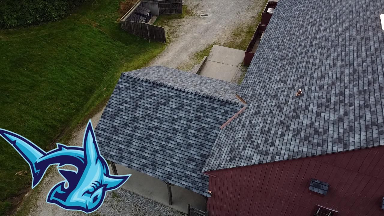 An overhead view of a completed Hammerhead roofing job with gray asphalt shingles