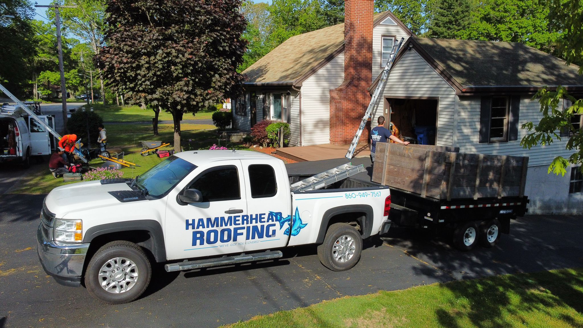Hammerhead roofing crews on location installing a new roof on a home