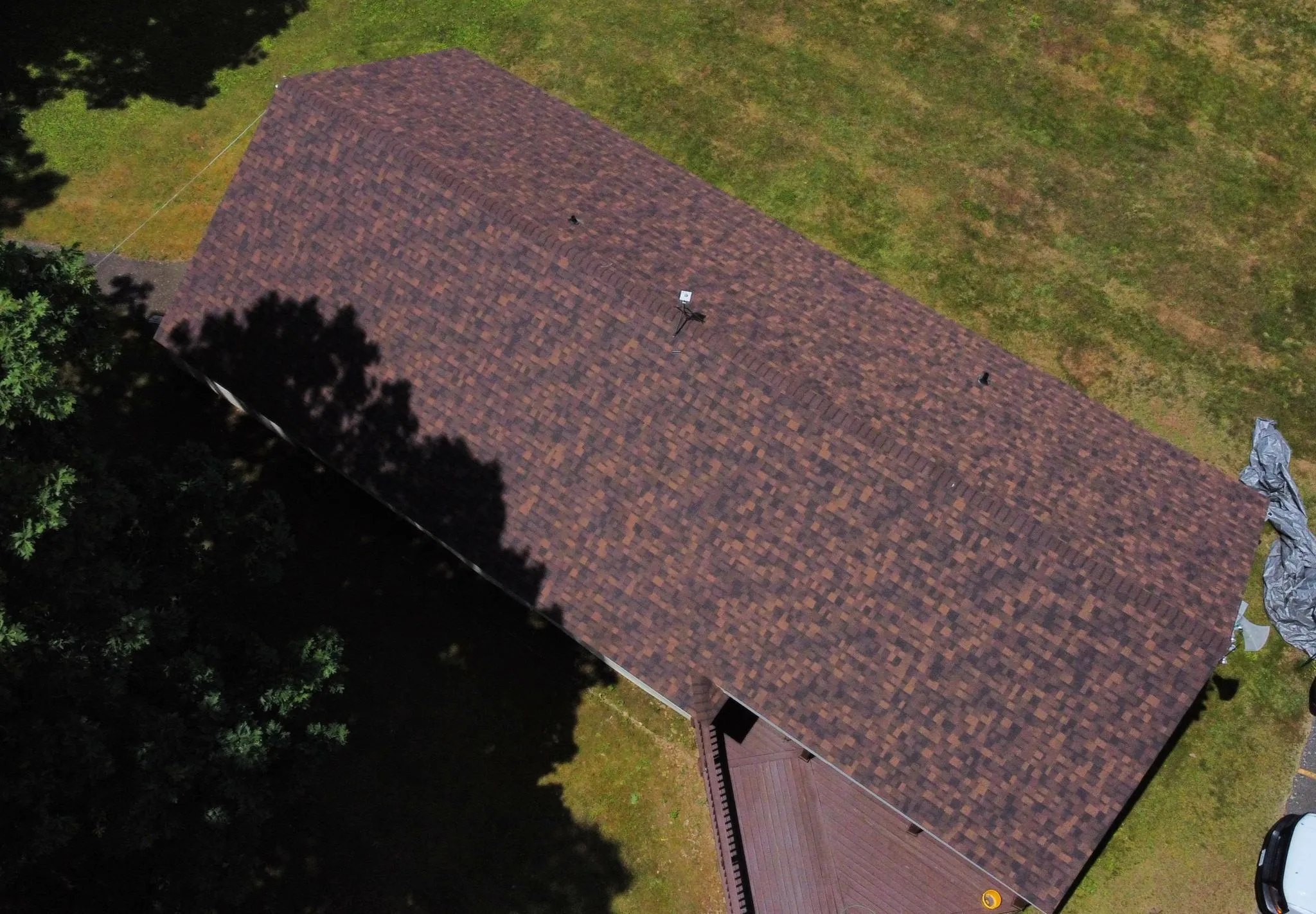 A drone view of a new home with redwood shingles installed by Hammerhead Roofing
