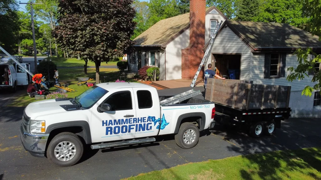 Hammerhead Roofing Crew at a residential home in Danielson, CT, performing gutter installation and roof repairs. 