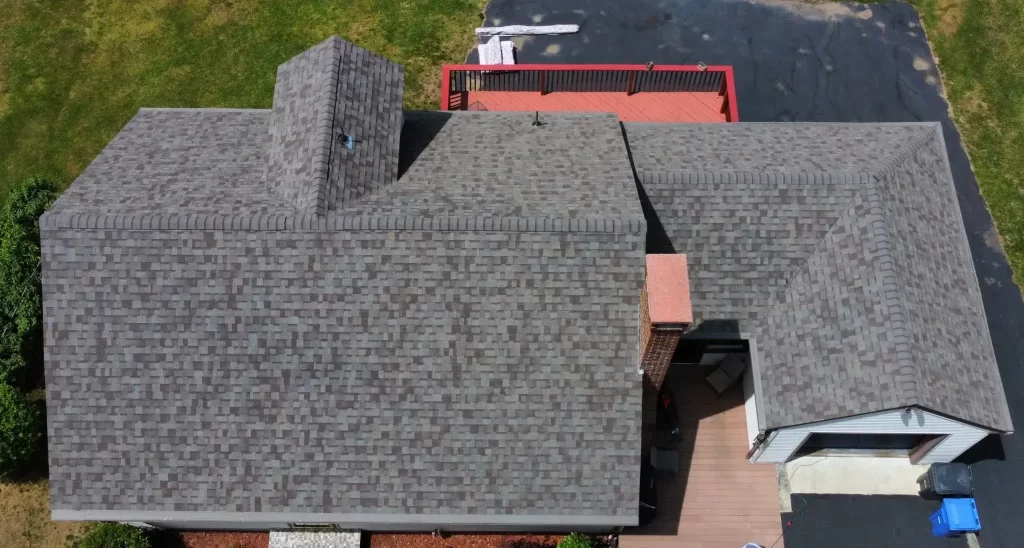 Aerial view of a residential home in Danielson, CT, with a recent roof replacement courtesy of Hammerhead Roofing.