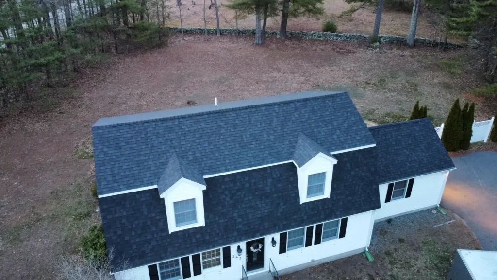 White residential home in Danielson, CT, with a recent roof cleaning courtesy of Hammerhead Roofing.
